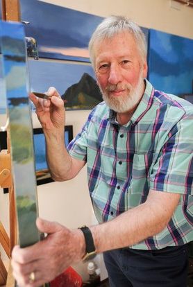 Image of the artist Stuart A Green painting at his easel.